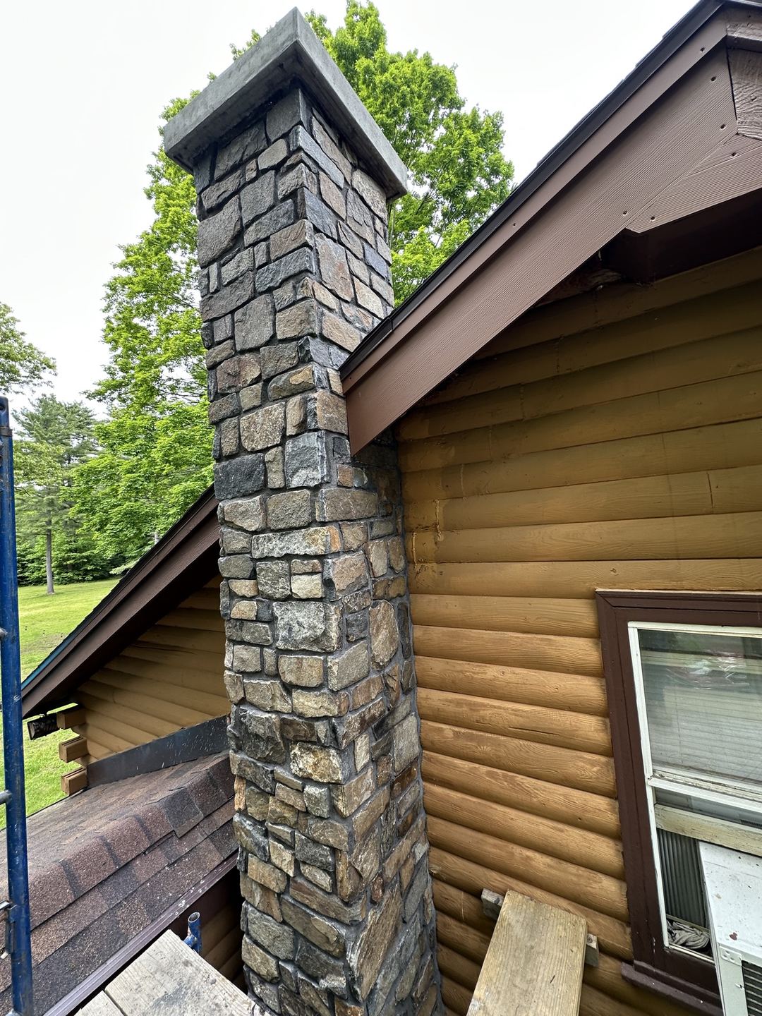 Finished top of the stone chimney with its cap and flue