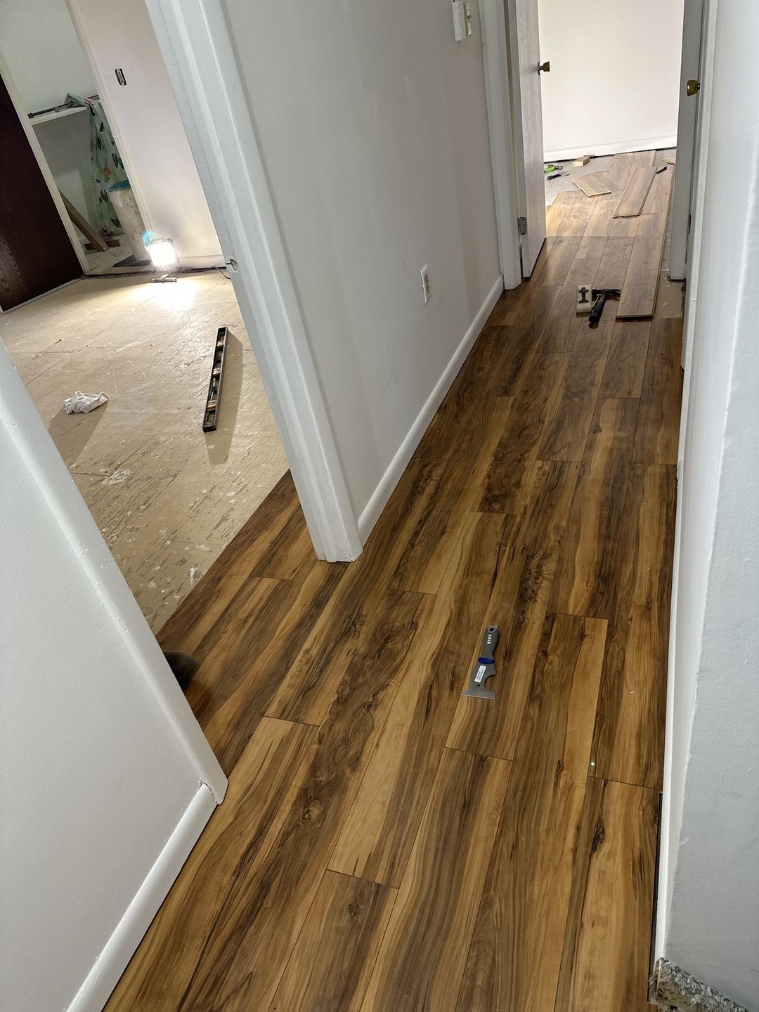 Hallway with new plank flooring nearly complete