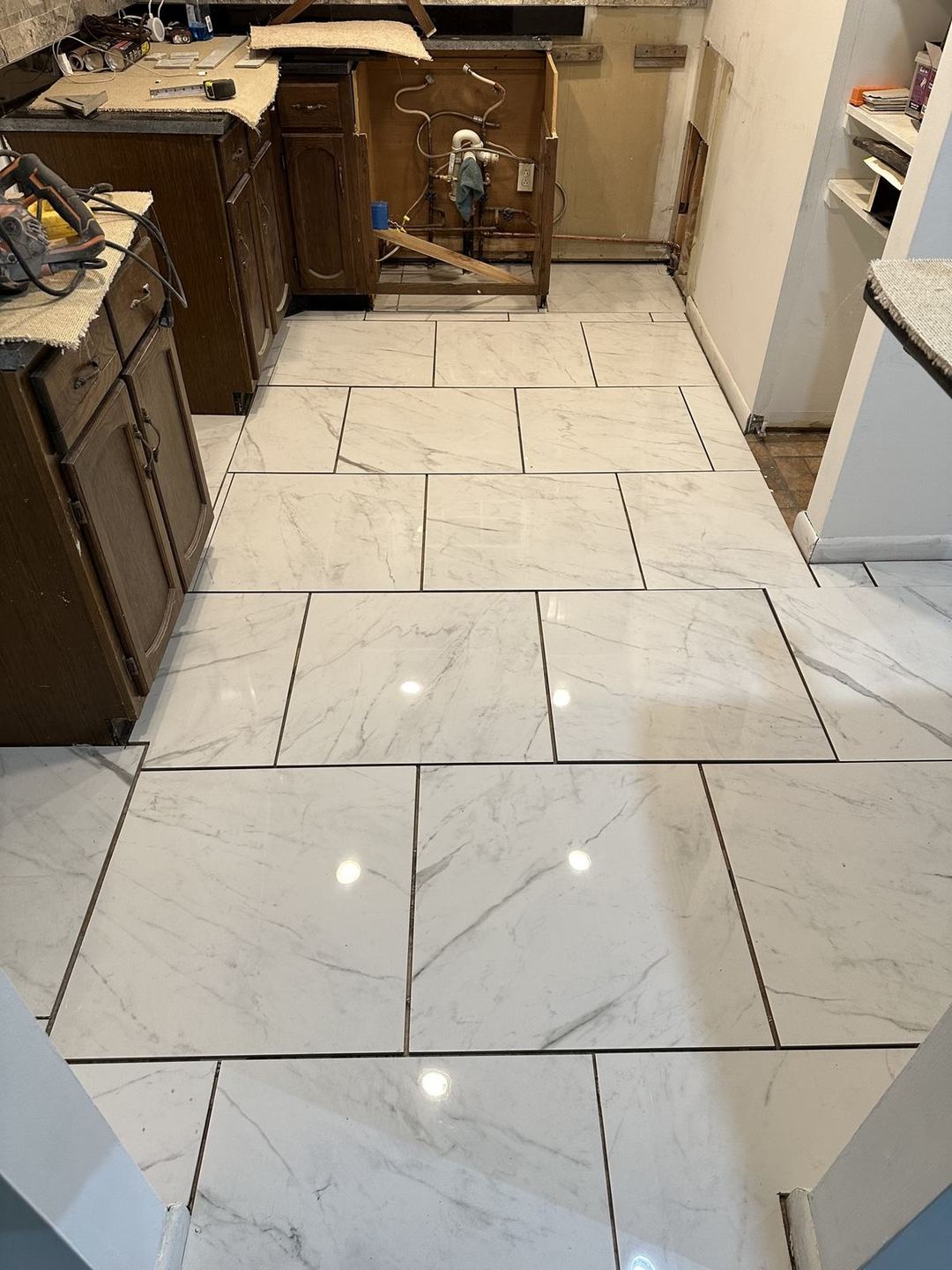 Marble-look tile kitchen floor with clean grout lines