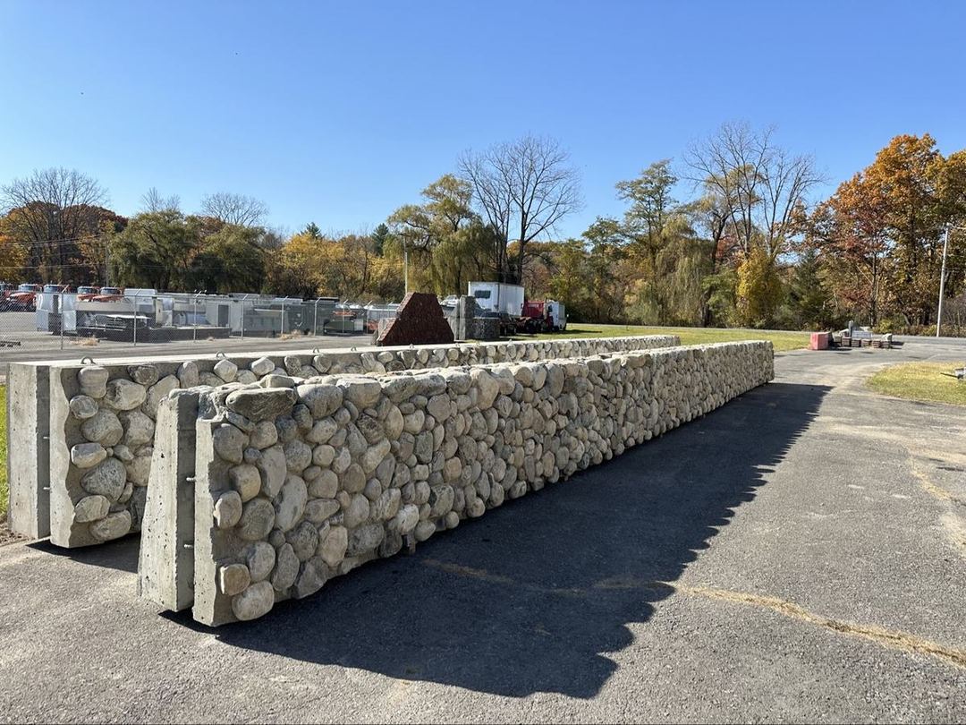 Fieldstone retaining wall panels standing in a sunny yard