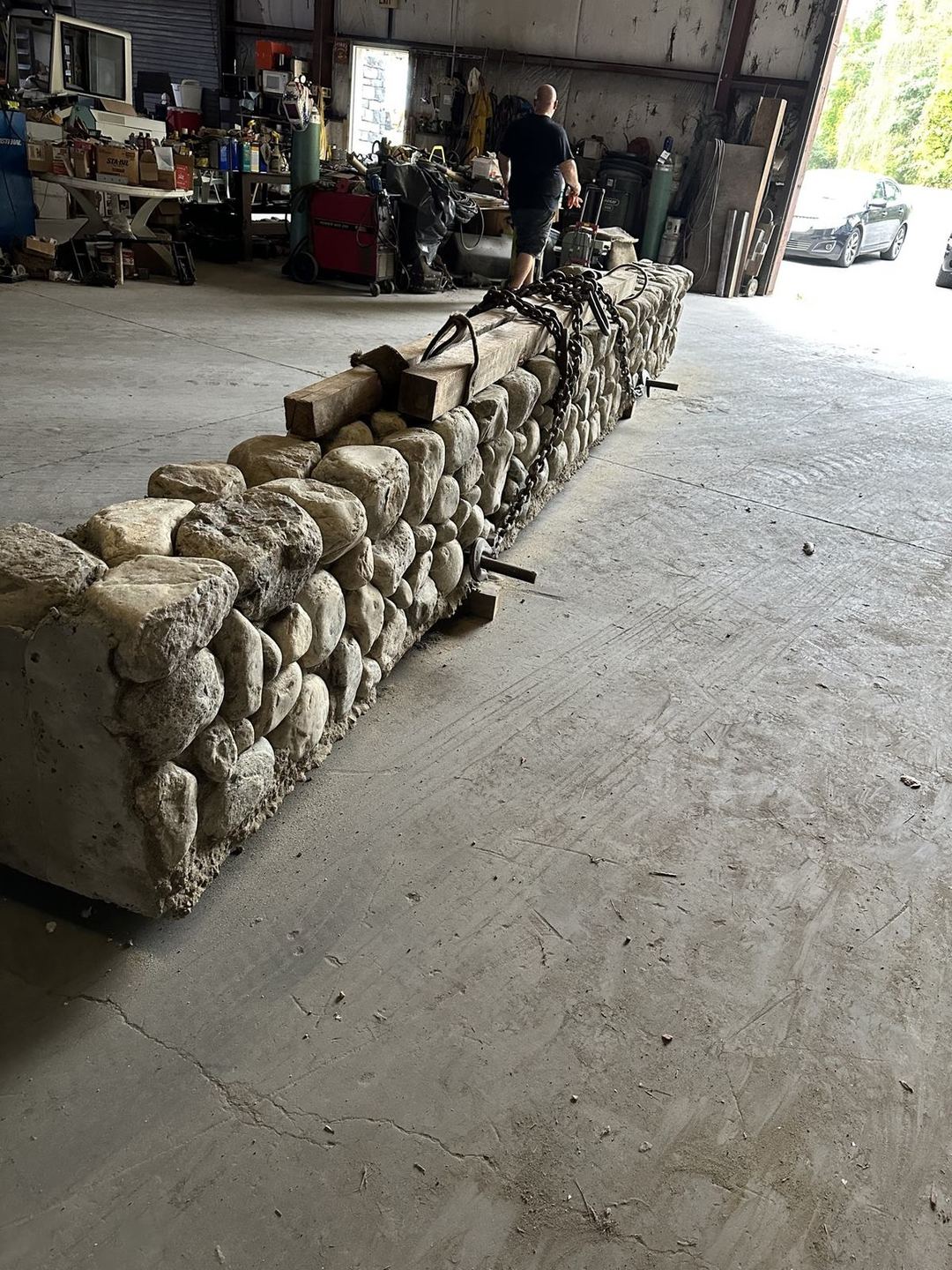 Stone wall panel chained for transport inside a warehouse